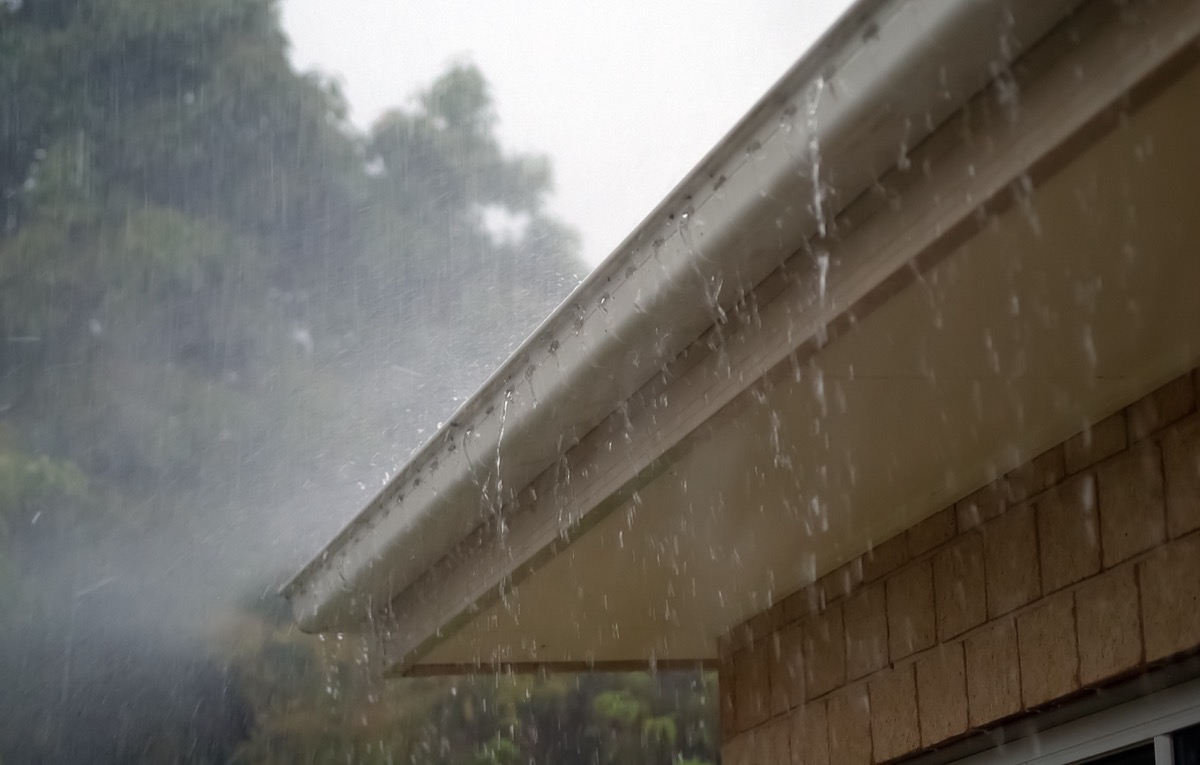 Rain gutter overflowing during heavy rainfall